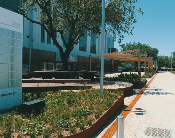 The Ion's exterior design, brought to life by Renfrow+Co, includes unique outdoor benches, corten steel planters, and geometric shade structures blending natural elements with modern architecture The Ion's exterior design, brought to life by Renfrow+Co, includes unique outdoor benches, corten steel planters, and geometric shade structures blending natural elements with modern architecture