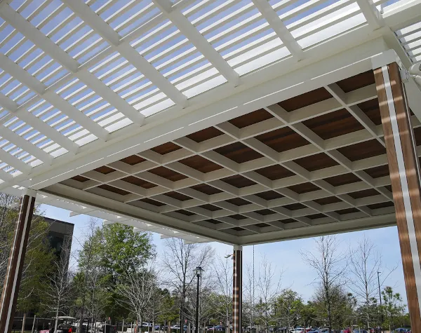 Top-tier metal fabrication in Houston showcasing an integrated cantilevered tube steel trellis and standing seam roof.