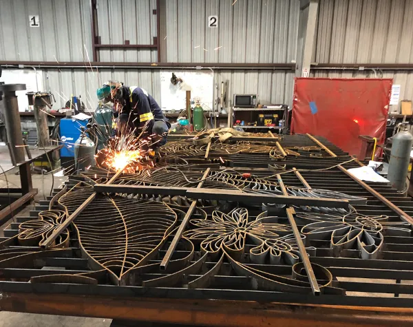 Renfrow+Co welder working on detailed decorative metal gates for the Houston Botanic Garden project Renfrow+Co welder working on detailed decorative metal gates for the Houston Botanic Garden project
