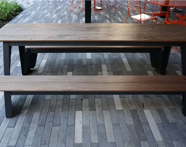 Renfrow+Co custom-built wooden bench with metal legs on a modern brick tile patio at JPMorgan Chase Tower outdoor space