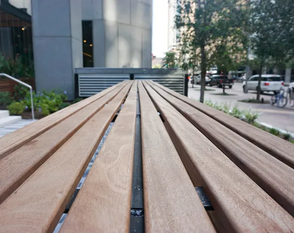 Close-up view of wooden bench slats fabricated and installed by Renfrow+Co at JPMorgan Chase Tower outdoor space