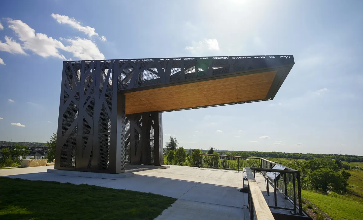 The Brown Foundation Hilltop Pavilion at Hill at Sims Park, featuring monumental custom metal fabrication by Renfrow+Co overlooking the Houston skyline.