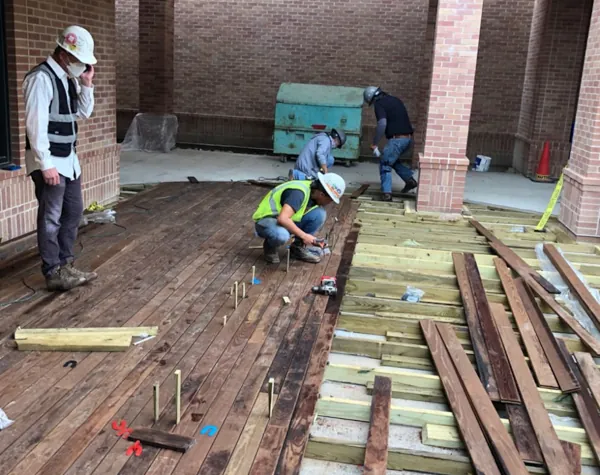 Renfrow+Co workers installing custom wood decking at St. Martin's Episcopal Church using Thermory Ash planks Renfrow+Co workers installing custom wood decking at St. Martin's Episcopal Church using Thermory Ash planks